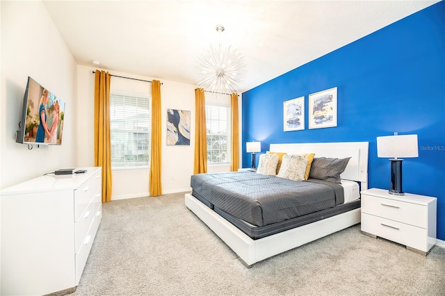 carpeted bedroom featuring a chandelier