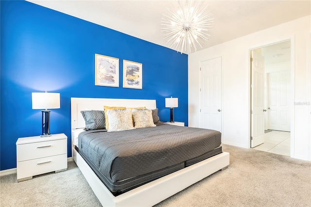 bedroom featuring an inviting chandelier and light carpet