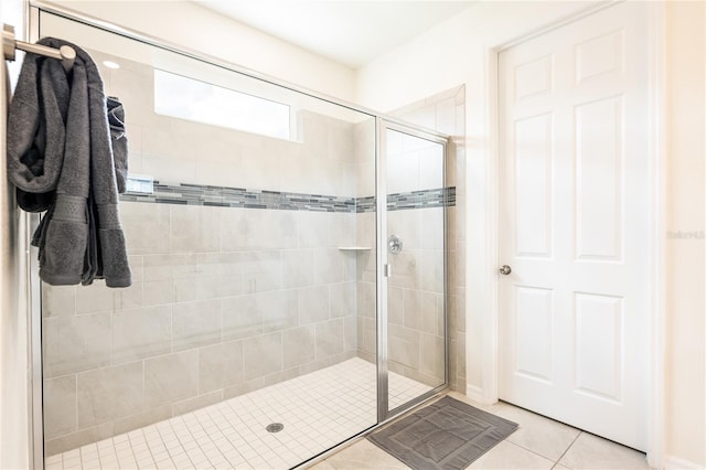 bathroom featuring tile patterned flooring and a shower with shower door