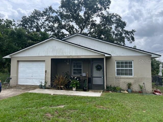 view of front of property with a garage and a front lawn