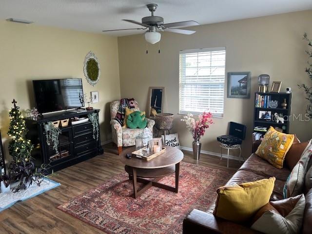 living room with ceiling fan and dark hardwood / wood-style floors