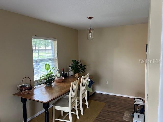 dining space with dark hardwood / wood-style flooring