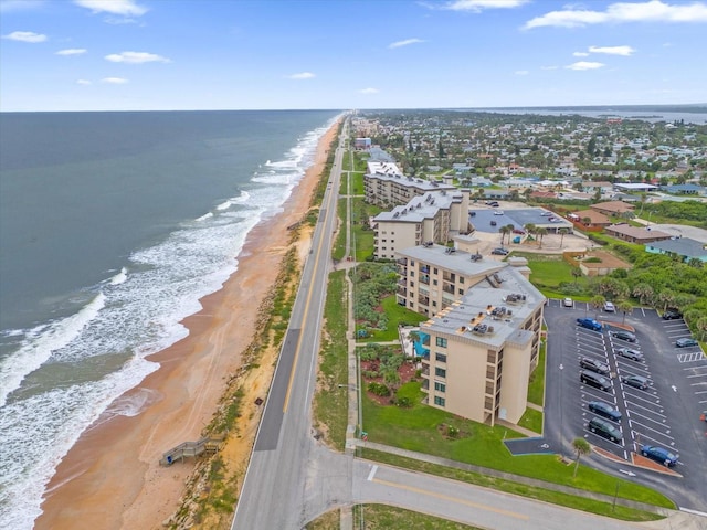 birds eye view of property featuring a water view and a beach view