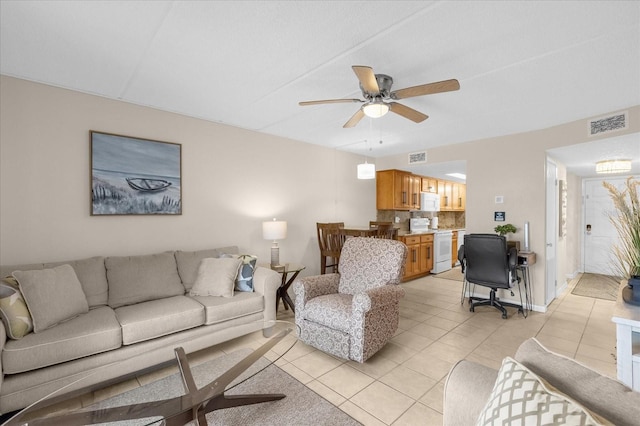 living room with ceiling fan and light tile patterned flooring