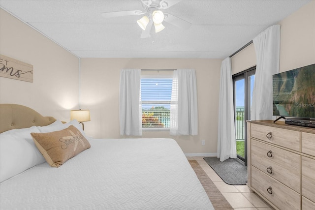 tiled bedroom featuring multiple windows, a textured ceiling, and ceiling fan