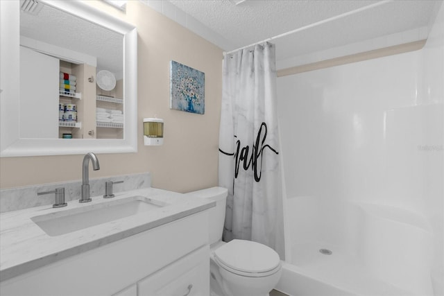 bathroom with vanity, toilet, a shower with shower curtain, and a textured ceiling