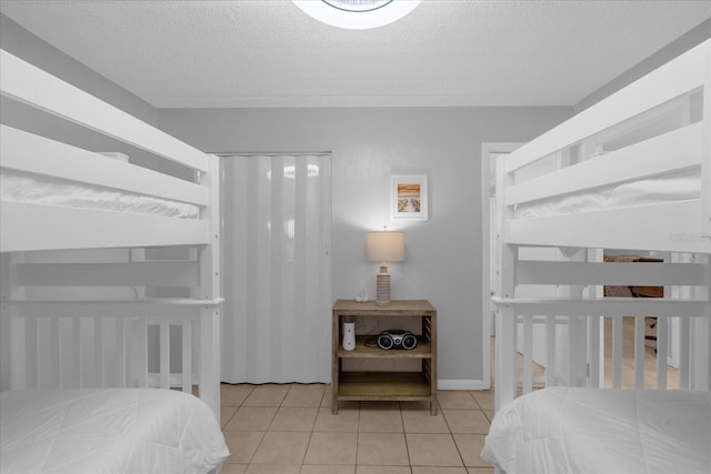 bedroom with light tile patterned flooring and a textured ceiling