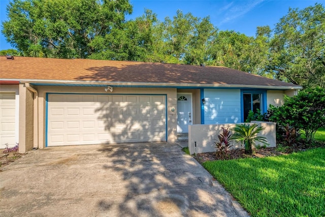 single story home with a front yard and a garage