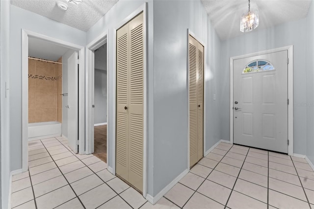 108 Clear Lake Cir, Sanford, FL 32773 - entrance foyer with a textured ceiling, baseboards, and light tile patterned floors