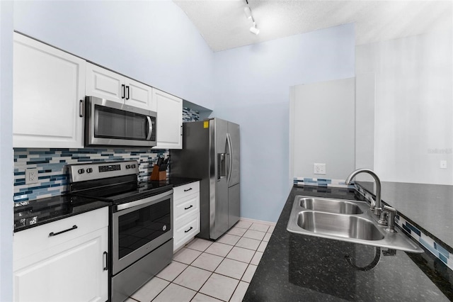 kitchen with light tile patterned flooring, stainless steel appliances, white cabinetry, and sink