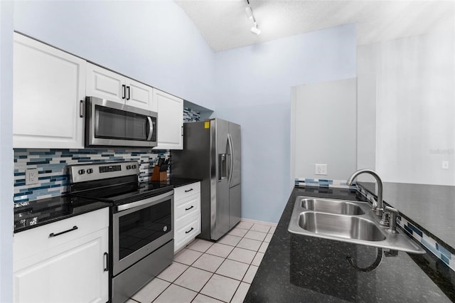 108 Clear Lake Cir, Sanford, FL 32773 - kitchen with a sink, white cabinetry, light tile patterned floors, stainless steel appliances, and decorative backsplash