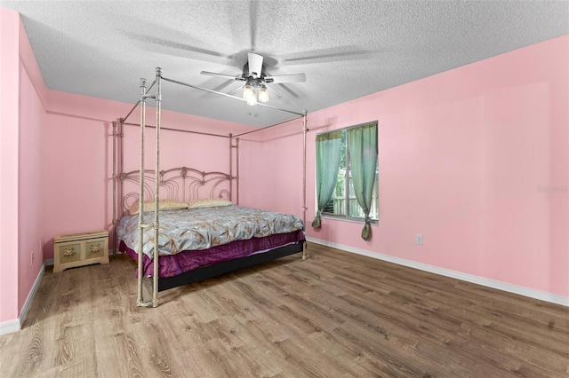 108 Clear Lake Cir, Sanford, FL 32773 - bedroom featuring baseboards, a textured ceiling, wood finished floors, and ceiling fan