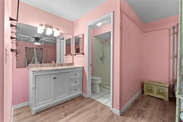108 Clear Lake Cir, Sanford, FL 32773 - bathroom featuring a shower, vanity, wood finished floors, a textured ceiling, and baseboards
