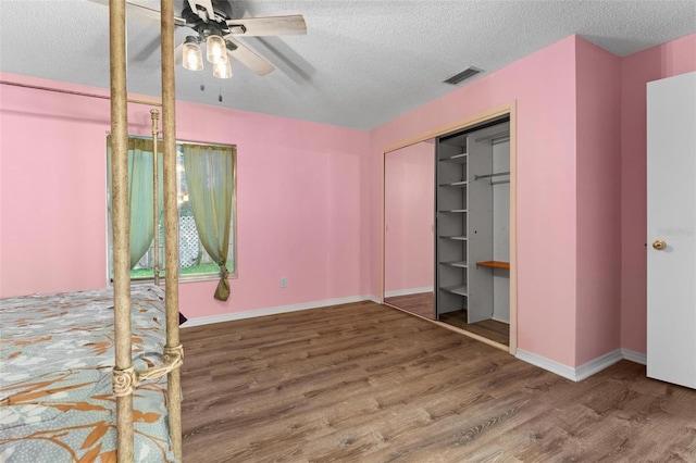 108 Clear Lake Cir, Sanford, FL 32773 - unfurnished bedroom with baseboards, a textured ceiling, visible vents, and wood finished floors