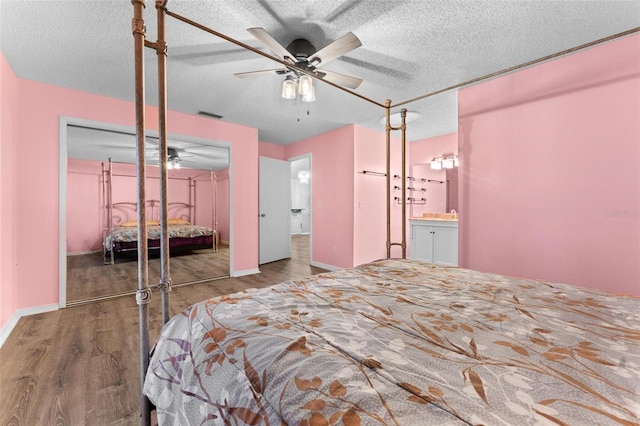 unfurnished bedroom with a textured ceiling, hardwood / wood-style floors, ceiling fan, and a closet