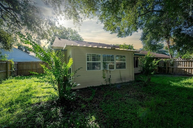108 Clear Lake Cir, Sanford, FL 32773 - back of house with a fenced backyard, a lawn, and cooling unit