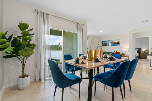 dining space featuring light tile patterned flooring