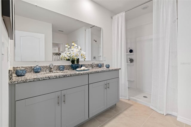 bathroom with vanity, walk in shower, and tile patterned flooring