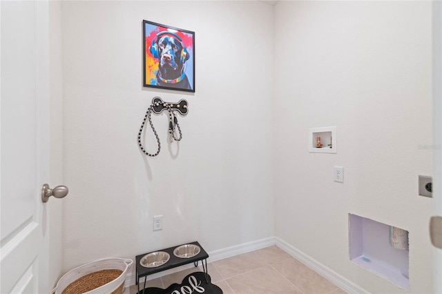 laundry area with hookup for a washing machine, hookup for an electric dryer, and light tile patterned flooring