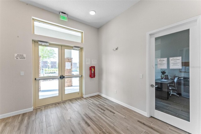 entryway featuring light wood-type flooring and french doors