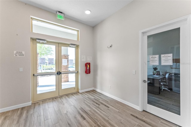 doorway to outside featuring french doors, baseboards, and wood finished floors