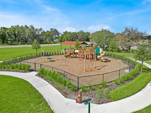 community playground with a yard and fence