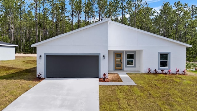 view of front of house with concrete driveway, stucco siding, a garage, and a front lawn