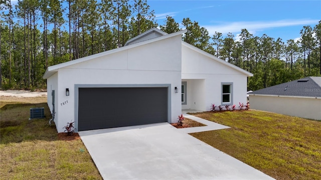 view of front of home featuring stucco siding, central AC, concrete driveway, and a front lawn