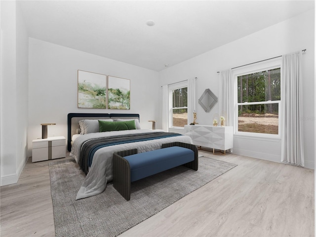 bedroom featuring baseboards and wood finished floors