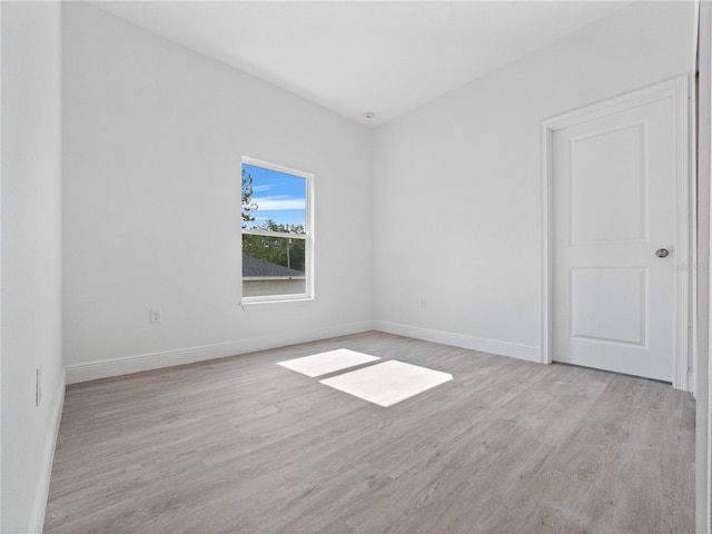 spare room with light hardwood / wood-style flooring