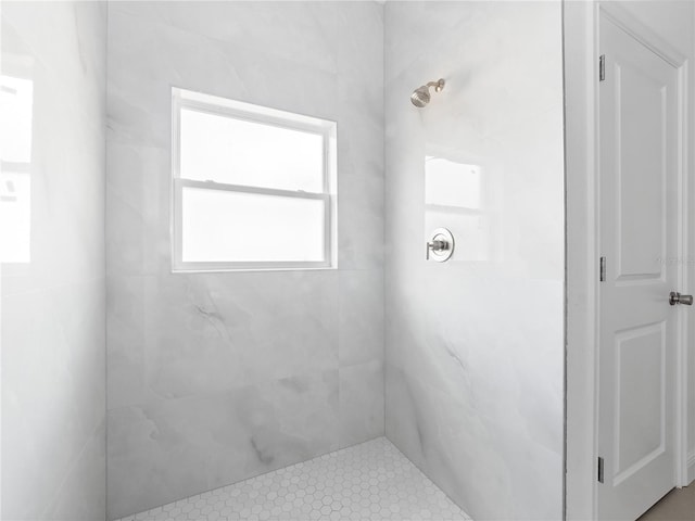 bathroom with a tile shower