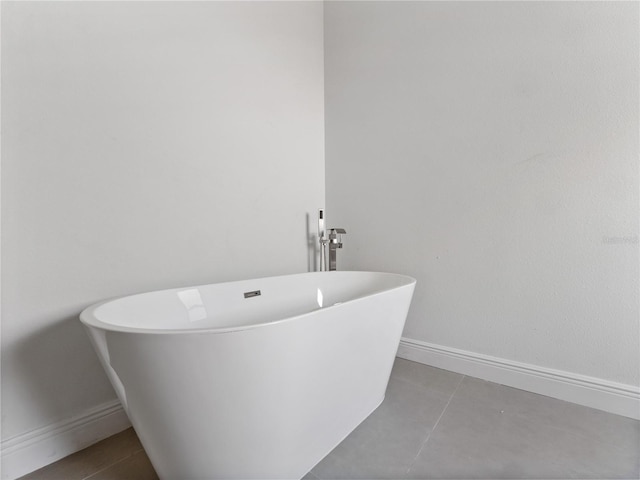 bathroom with a tub and tile patterned floors