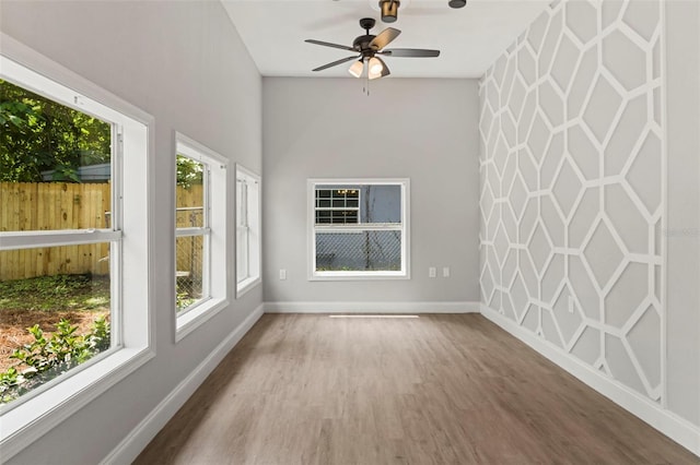 interior space featuring hardwood / wood-style floors and ceiling fan