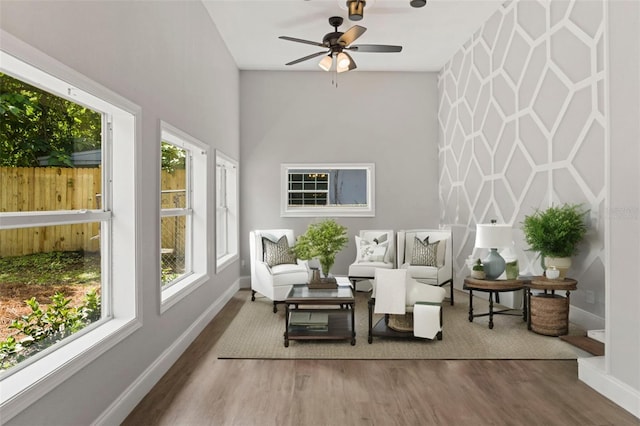 sunroom featuring ceiling fan