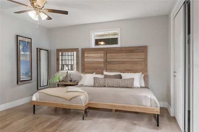 bedroom with light wood-type flooring and ceiling fan