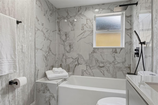 full bathroom featuring vanity, toilet, and tiled shower / bath