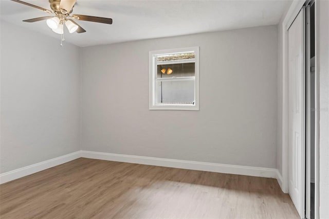 empty room with ceiling fan and light hardwood / wood-style floors