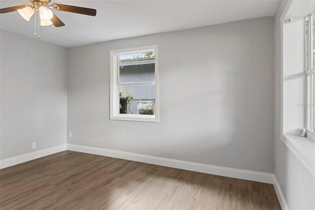 empty room featuring ceiling fan and dark hardwood / wood-style floors