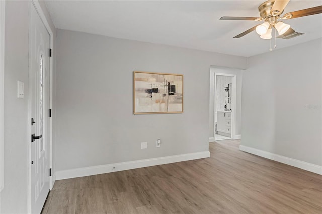 empty room featuring light wood-type flooring and ceiling fan