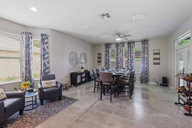 dining area featuring concrete floors and ceiling fan