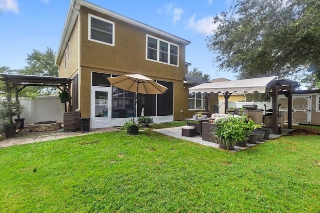 rear view of house with a yard and a patio