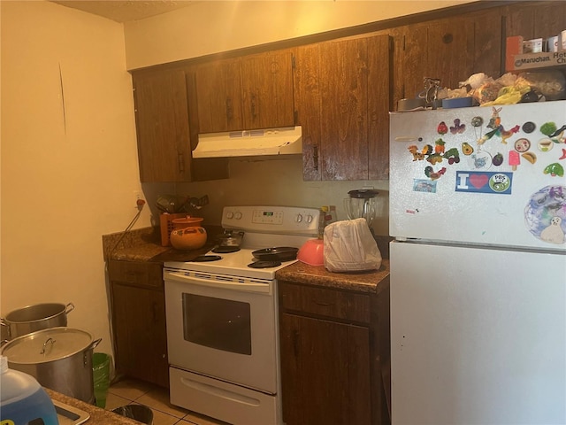 kitchen with white appliances and light tile patterned flooring