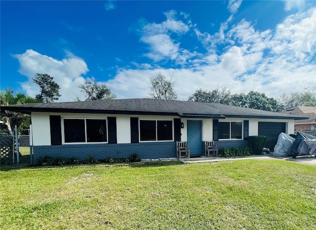 single story home featuring a garage and a front yard