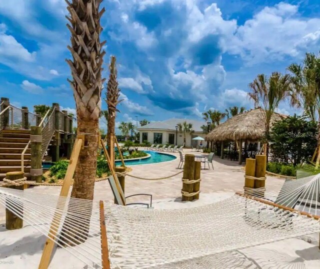 exterior space with a community pool, a gazebo, and a patio