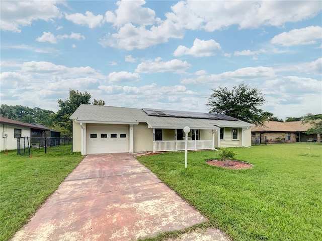 single story home with a porch, a garage, solar panels, and a front yard