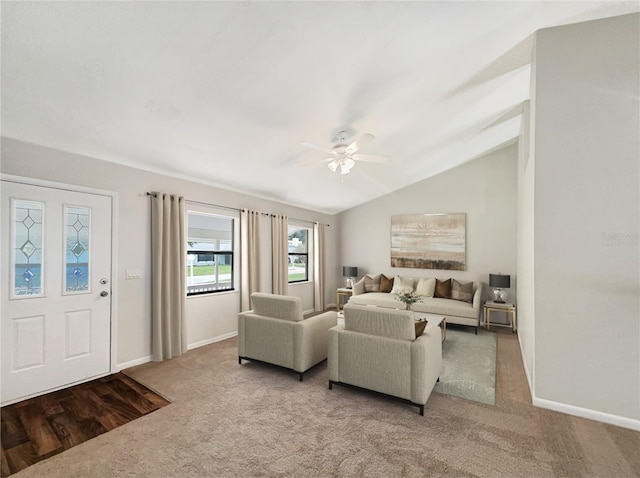 living room with ceiling fan, hardwood / wood-style flooring, and vaulted ceiling