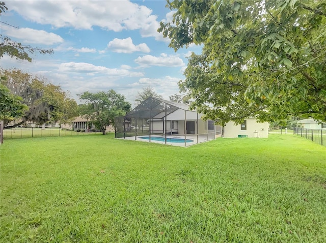 view of yard featuring glass enclosure and a fenced in pool