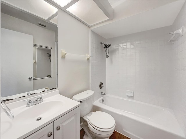 full bathroom with tiled shower / bath combo, vanity, toilet, and hardwood / wood-style flooring