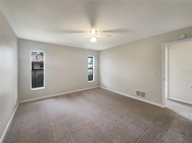 spare room with carpet flooring and ceiling fan