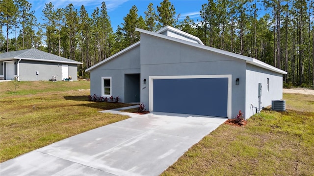 view of front facade featuring stucco siding, driveway, a front yard, an attached garage, and central AC unit